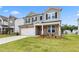 Two-story home with gray siding, stone accents, well-manicured lawn, and a two car garage at 722 Crossroad Ct, Powder Springs, GA 30127