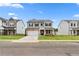 Beautiful two-story home with gray siding, stone accents, a well-manicured lawn, and a two car garage at 722 Crossroad Ct, Powder Springs, GA 30127