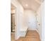 Bright hallway with built-in bench, hardwood floors, and access to bathroom and closets at 722 Crossroad Ct, Powder Springs, GA 30127