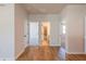 Bright hallway with hardwood floors leading to bedrooms and a bathroom at 722 Crossroad Ct, Powder Springs, GA 30127