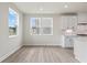 Eat-in kitchen with white cabinets, light countertops and multiple windows at 722 Crossroad Ct, Powder Springs, GA 30127