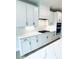 Gourmet kitchen boasts white cabinets, quartz counters, stainless appliances, and modern finishes at 722 Crossroad Ct, Powder Springs, GA 30127