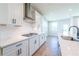 Modern kitchen with white cabinets, quartz countertops, and stainless steel appliances at 722 Crossroad Ct, Powder Springs, GA 30127