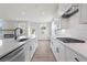 Bright kitchen featuring white cabinetry, quartz countertops, and stainless steel appliances at 722 Crossroad Ct, Powder Springs, GA 30127