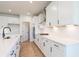 Modern kitchen with white cabinets, quartz countertops, and stainless steel appliances at 722 Crossroad Ct, Powder Springs, GA 30127