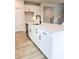 Close-up of kitchen island featuring white quartz countertop, stainless steel sink, black faucet, and bar seating at 722 Crossroad Ct, Powder Springs, GA 30127
