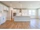 Modern kitchen with white cabinets, quartz countertops, and a large island at 722 Crossroad Ct, Powder Springs, GA 30127