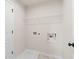 Well-equipped laundry room with utility sink, shelving, and white cabinets at 722 Crossroad Ct, Powder Springs, GA 30127