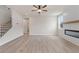 Open-concept living room with modern fireplace, neutral paint, and staircase access at 722 Crossroad Ct, Powder Springs, GA 30127