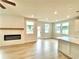 Open-concept living space featuring an electric fireplace, recessed lighting, hardwood floors, and kitchen island at 722 Crossroad Ct, Powder Springs, GA 30127
