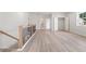 Upstairs loft area with light colored flooring and a staircase at 722 Crossroad Ct, Powder Springs, GA 30127