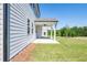 Covered patio with ceiling fan and adjacent grassy area at 722 Crossroad Ct, Powder Springs, GA 30127
