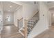 Bright foyer showcasing an elegant staircase with wood and black metal railing detail at 722 Crossroad Ct, Powder Springs, GA 30127