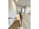 Bright open stairway features wood stairs, a modern railing, and light-colored floors for a contemporary feel at 722 Crossroad Ct, Powder Springs, GA 30127
