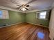 Serene bedroom painted in a calming green hue, featuring hardwood floors at 308 Mountain Brook Rd, Cumming, GA 30040