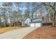 Two-story house with gray siding, a two-car garage, and a long driveway at 4006 Maxanne Nw Dr, Kennesaw, GA 30144