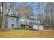 Gray sided two story house with a deck, two car garage, and large yard at 4006 Maxanne Nw Dr, Kennesaw, GA 30144