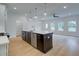 Open concept kitchen with island, stainless steel appliances, and hardwood floors at 1608 Ruskin Way, Marietta, GA 30062