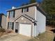 Brick and gray-sided two-story house with a white garage door at 3116 Leyland Ct, Decatur, GA 30034