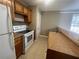 Kitchen with wood cabinets, white appliances, and laminate countertops at 3116 Leyland Ct, Decatur, GA 30034