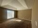 Spacious main bedroom with a tray ceiling, brown carpet, and large window at 3116 Leyland Ct, Decatur, GA 30034