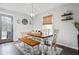 Bright dining area with wooden table, bench and access to deck at 326 Scarlett Ln, Woodstock, GA 30188