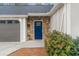 Welcoming front entry with a blue door and stone accents at 326 Scarlett Ln, Woodstock, GA 30188