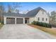 Two-car garage with driveway and landscaping at 326 Scarlett Ln, Woodstock, GA 30188