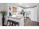 Updated kitchen featuring white cabinets and granite island at 326 Scarlett Ln, Woodstock, GA 30188