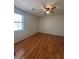 Bright bedroom with wood-look floors and ceiling fan at 5250 Mountain Village Ct, Stone Mountain, GA 30083