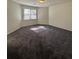 Spacious bedroom with plush carpeting and large window at 5250 Mountain Village Ct, Stone Mountain, GA 30083