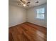 Well-lit bedroom featuring wood-look floors and a ceiling fan at 5250 Mountain Village Ct, Stone Mountain, GA 30083