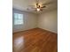 Bright bedroom with hardwood floors and a ceiling fan at 5250 Mountain Village Ct, Stone Mountain, GA 30083