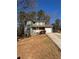 Green two-story house with a red roof and a stone facade at 5250 Mountain Village Ct, Stone Mountain, GA 30083