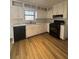 Galley kitchen with white cabinets and black appliances at 5250 Mountain Village Ct, Stone Mountain, GA 30083