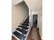 Modern black and white staircase with wood flooring and simple railing at 5250 Mountain Village Ct, Stone Mountain, GA 30083