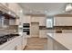 Modern kitchen with white cabinets, gas cooktop and built-in ovens at 4090 Glasnill Rd, Suwanee, GA 30024