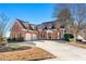 Brick house with a three-car garage and manicured lawn at 4901 Planters Walk, Douglasville, GA 30135