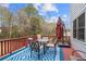 Relaxing outdoor deck featuring a dining table, umbrella, and pleasant views at 1867 Falcon Wood Ne Dr, Marietta, GA 30066