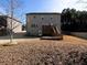 Exterior view of a well-maintained backyard featuring a deck, patio, and ample green space for outdoor activities at 4417 Green Pastures Way, Ellenwood, GA 30294