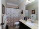 Well-maintained bathroom with a floral shower curtain and plenty of counter space at 4417 Green Pastures Way, Ellenwood, GA 30294