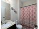 Bright bathroom featuring a shower with stylish patterned curtain, modern vanity, and neutral wall decor at 4417 Green Pastures Way, Ellenwood, GA 30294