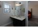 Bathroom featuring vanity with granite countertop, framed mirror, and window at 4417 Green Pastures Way, Ellenwood, GA 30294