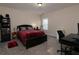 Bedroom with a bed, desk, bookcase, and neutral color scheme at 4417 Green Pastures Way, Ellenwood, GA 30294