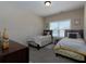 Bedroom featuring two twin beds with a window providing natural light at 4417 Green Pastures Way, Ellenwood, GA 30294