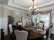 Dining room showcasing elegant chairs, dark wood table and decorative chandelier at 4417 Green Pastures Way, Ellenwood, GA 30294