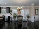 Elegant dining area with a glass table and direct access to the backyard through French doors at 4417 Green Pastures Way, Ellenwood, GA 30294