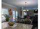 Bright and airy dining area with chandelier, seamlessly connected to the living space at 4417 Green Pastures Way, Ellenwood, GA 30294