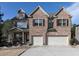 Charming brick home featuring a two-car garage and inviting front porch on a sunny day at 4417 Green Pastures Way, Ellenwood, GA 30294