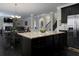 Stylish kitchen island with granite countertop and stainless steel refrigerator, ideal for entertaining at 4417 Green Pastures Way, Ellenwood, GA 30294